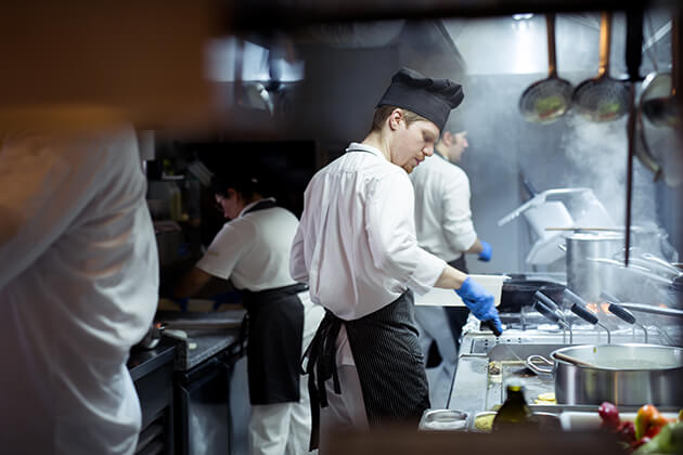 Photo of chef cooking in a restaurant kitchen