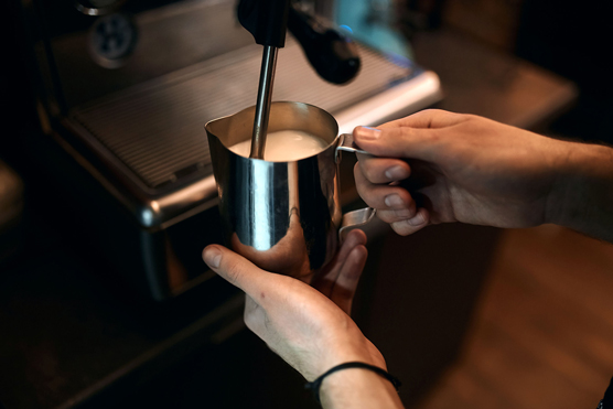 barista steams the milk