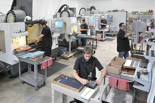 men working in factory checking for quality