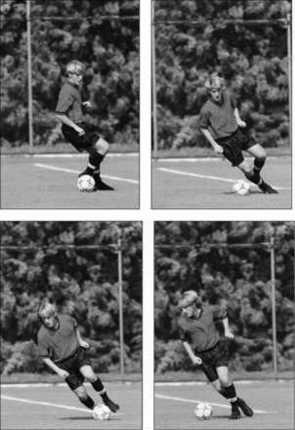 A soccer player turns with a ball.