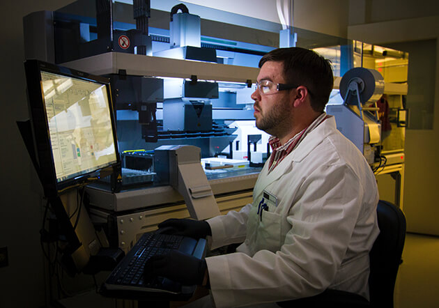 Photo of a young man working as a lab technician