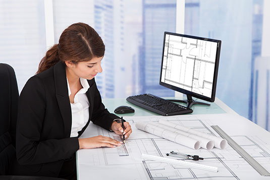 woman sitting in front of computer working on contract