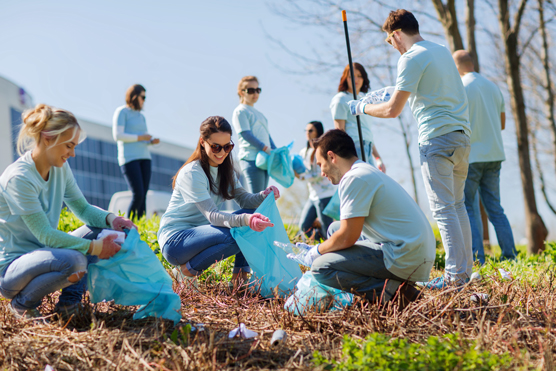 Volunteers having fun while cleaning a community park