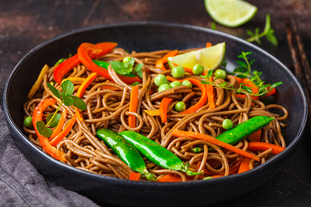 Photo of bowl filled with soba noodle salad with vegetables