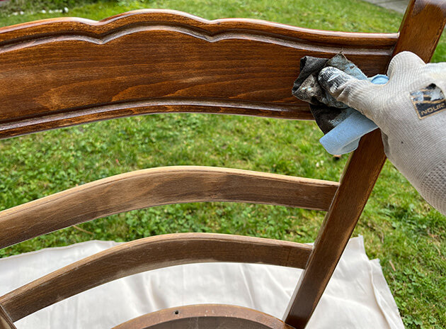 Photo showing applying new stain on an antique chair