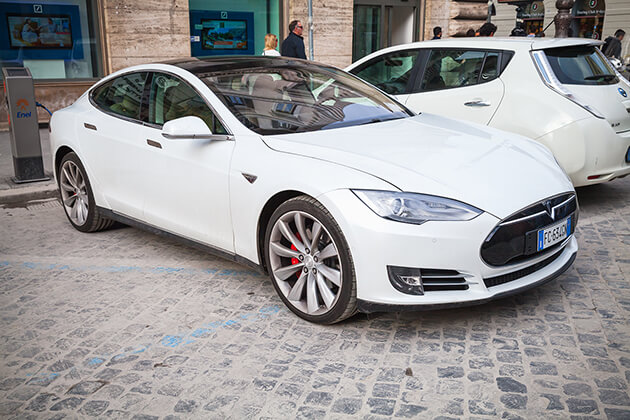 Photo of a white Tesla Model S electric vehicle.