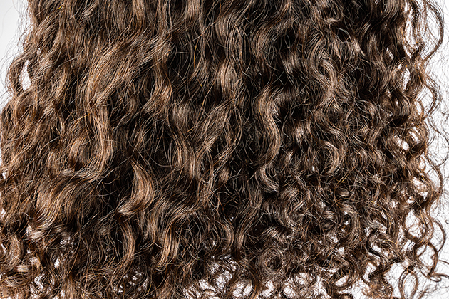 Close-up of brown type 2 hair with loose curls