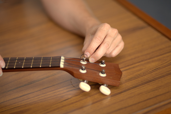 Looping the string around the tuning peg.