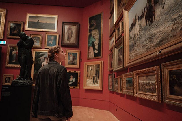 Woman looking at paintings