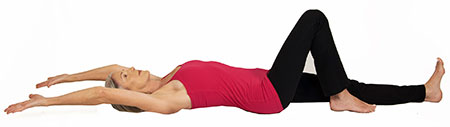 Lie on your back with one leg bent and one leg straight.