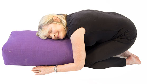 Child’s pose with a bolster.